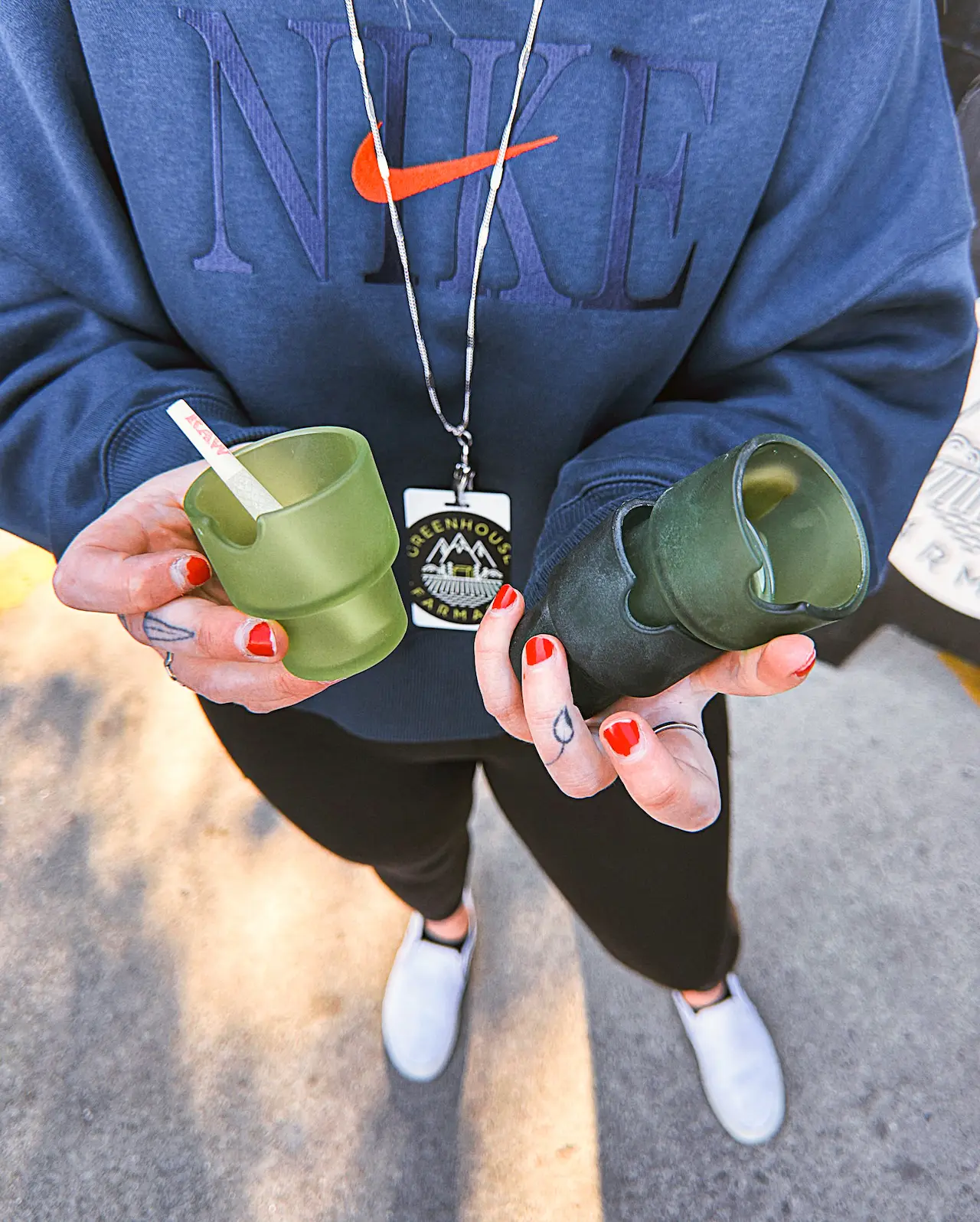 Close up look of hands holding 3 options of the flower pot stackable ashtrays from NTWN Homes