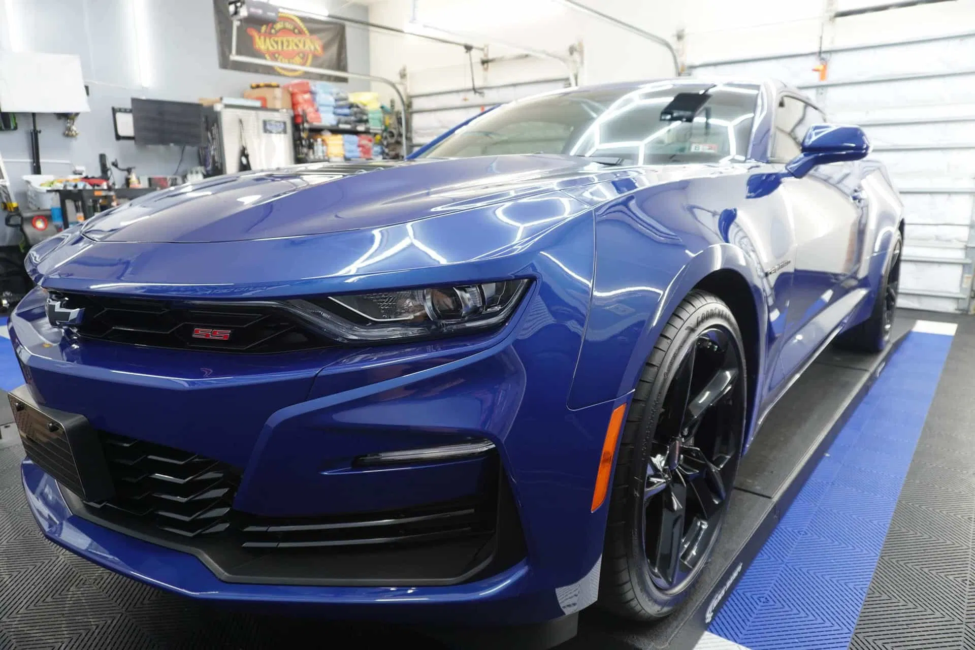 A blue Chevrolet Camaro SS featuring a flawless, high-gloss finish that showcases expert paint correction and ceramic coating.