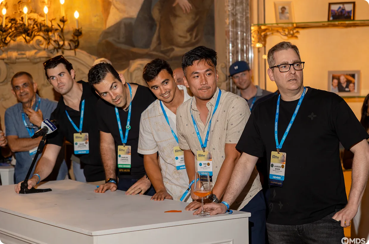 Group of summit attendees gathered around a table