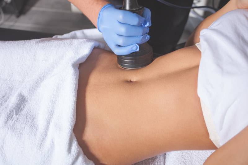 Person's abdomen receiving ultrasound therapy.