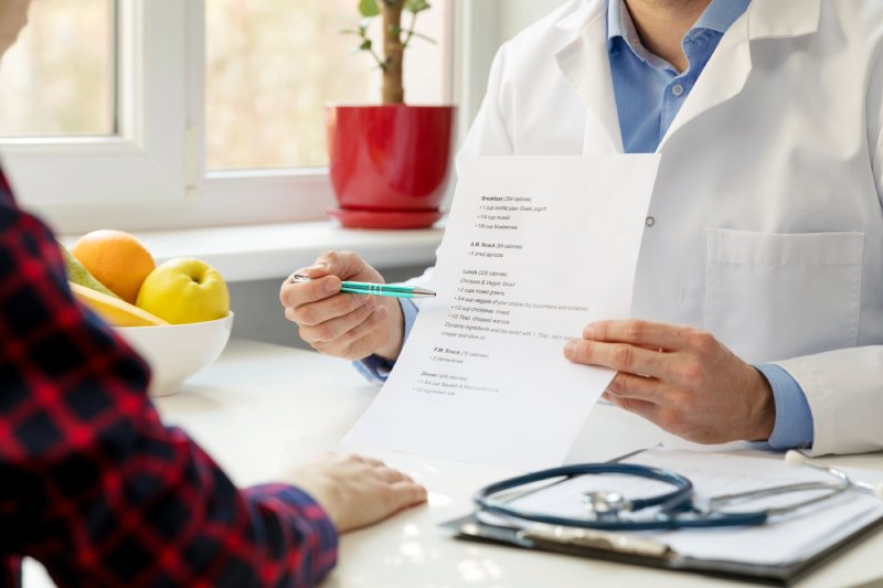 Doctor discussing paperwork with patient.