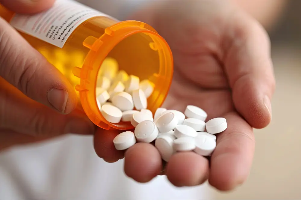 Prescription pills being poured into hand.
