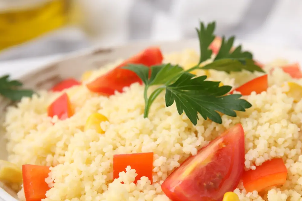 Couscous with tomato and parsley garnish.