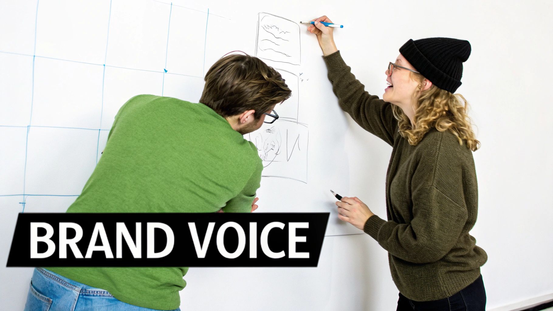 Two people collaboratively drawing sketches and ideas on a whiteboard, focusing on brand voice.