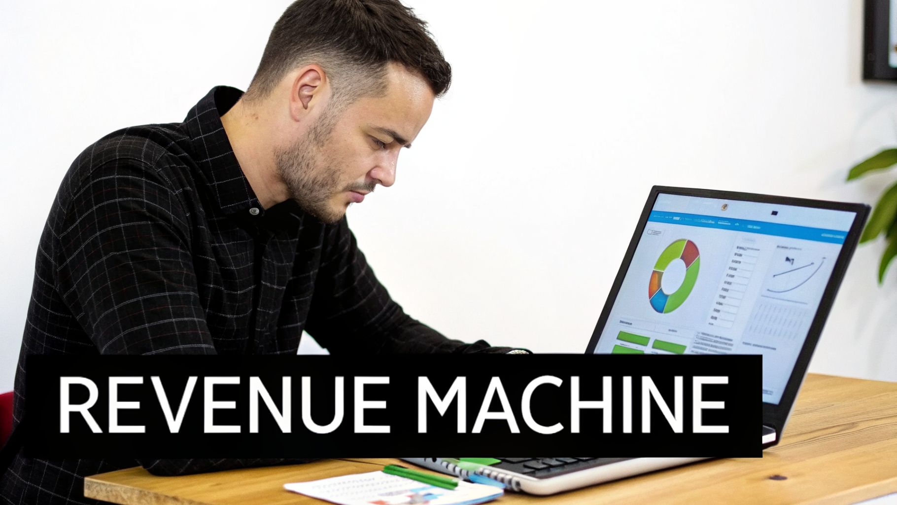 A man focused on a laptop displaying business charts, with a 'REVENUE MACHINE' banner.