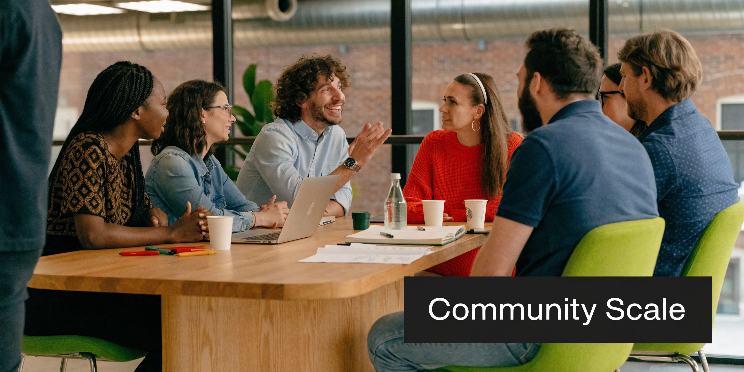 A diverse group of professional ecom founders collaborating during a team meeting in a modern office space.