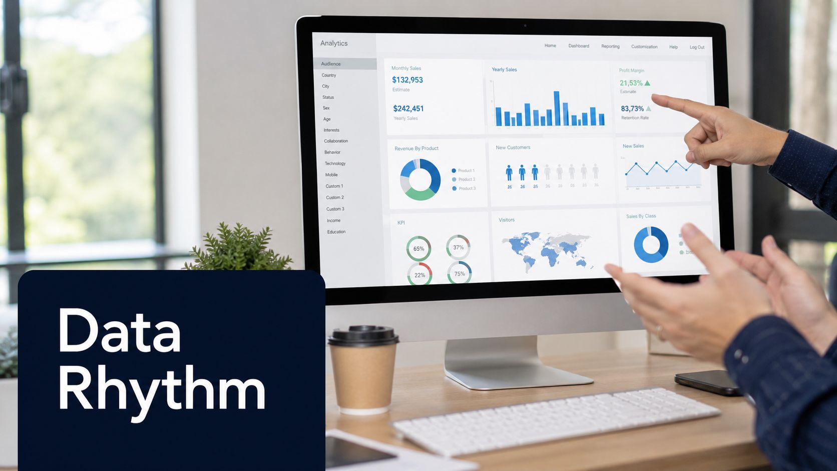 A professional business meeting with a person pointing at business analytics on a desktop computer screen.
