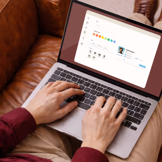 Person typing on a laptop showing a user profile and interface with color selection options.