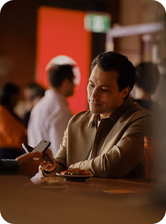 Professional capturing a lead on his smartphone at a networking event.