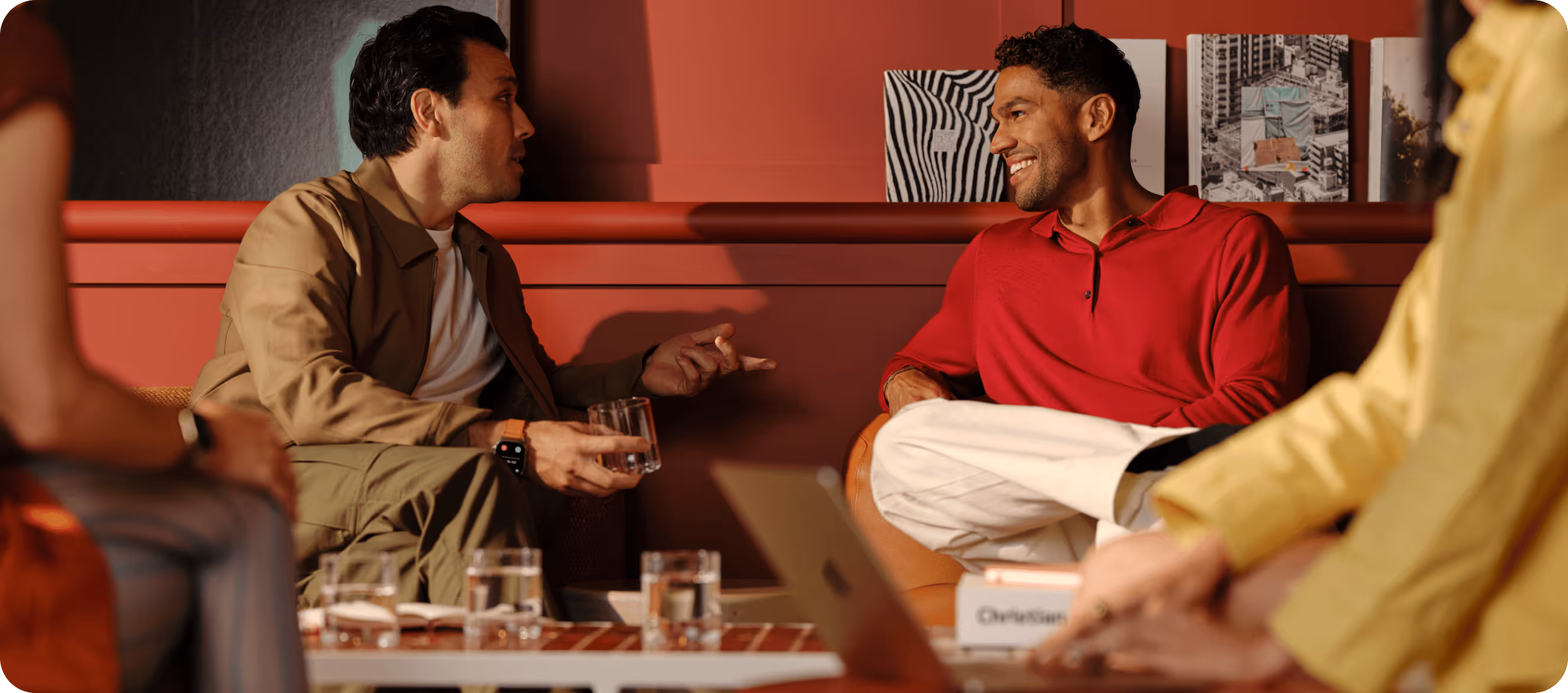 Professionals having an informal conversation over drinks - the kind of relationship-building moment Blinq's AI Notetaker is designed to capture