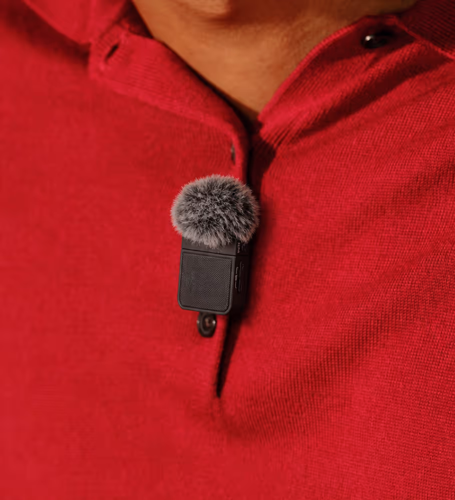 Bluetooth lapel microphone clipped to clothing for clearer AI Notetaker recordings in noisy environments