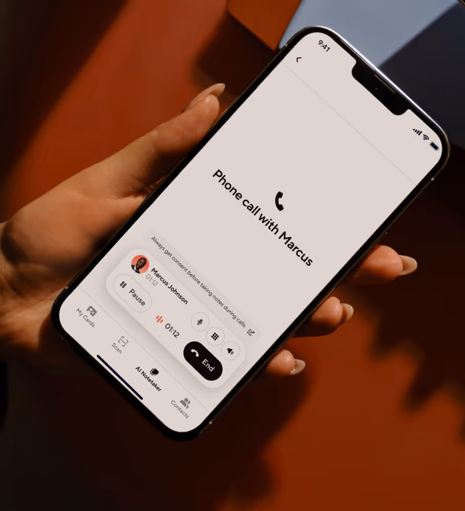 Hand holding smartphone with Blinq AI Notetaker active during a phone call, generating a summary in real time