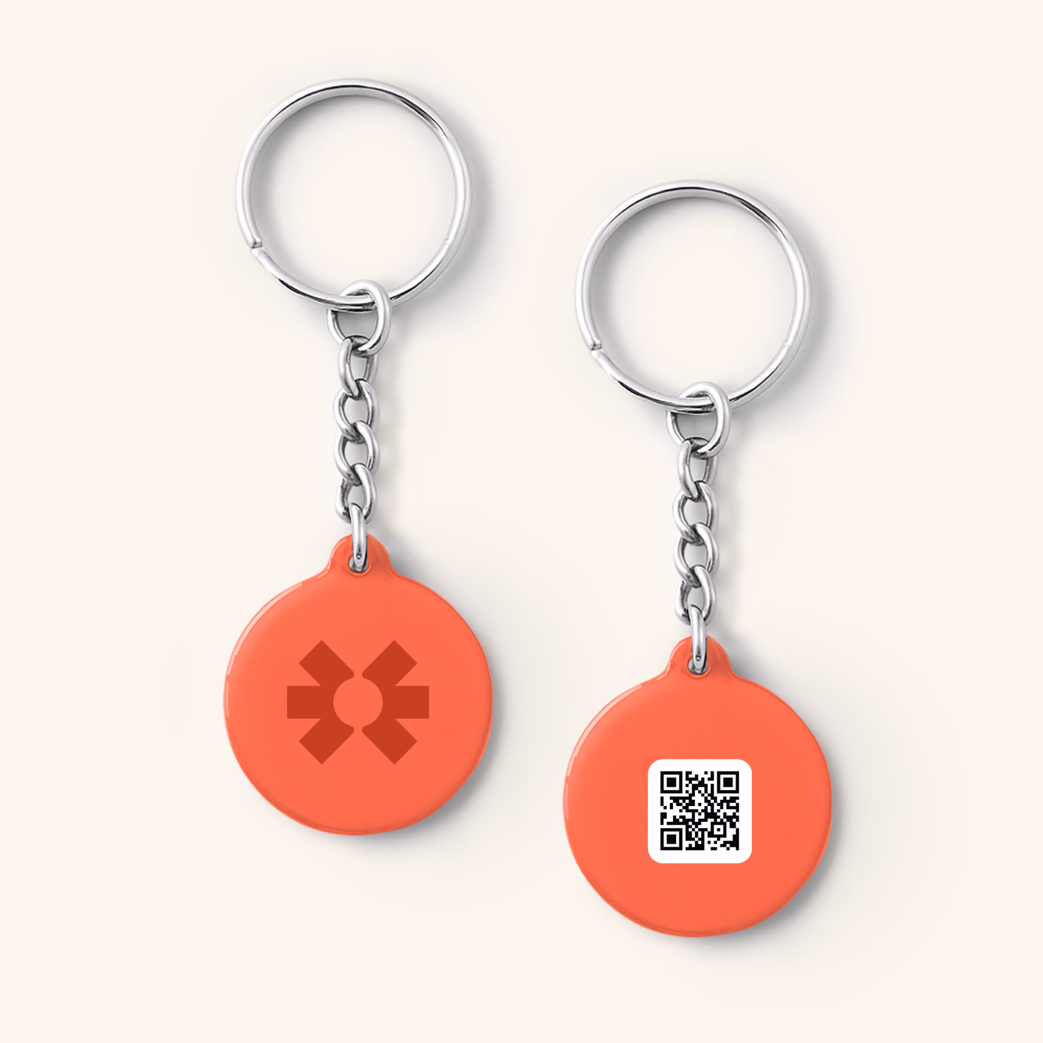 Two coral Blinq NFC keychain fobs with the Blinq logo and a QR code on split rings