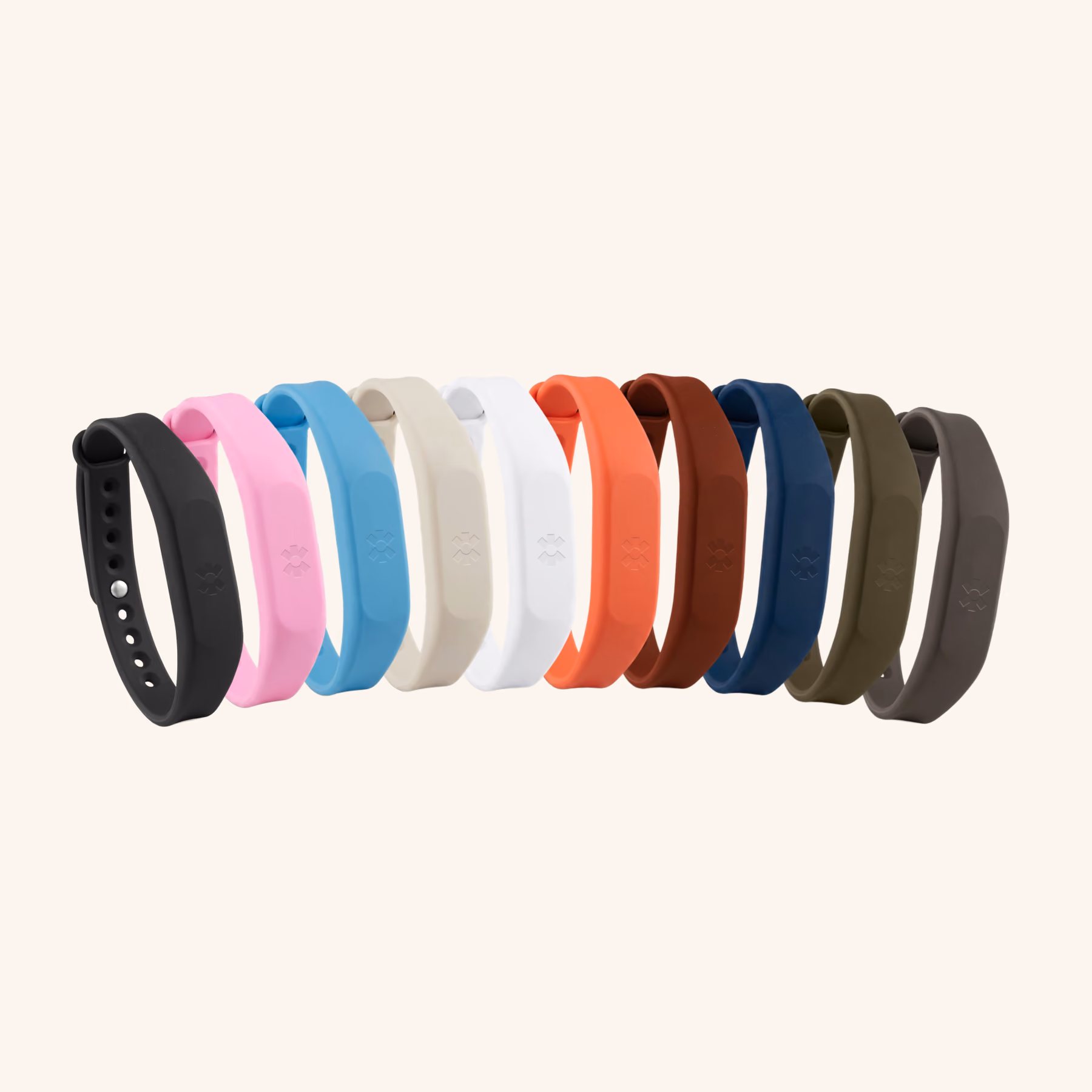 Ten Blinq NFC wristbands lined up in black, pink, blue, sand, white, orange, rust, navy, olive and grey silicone