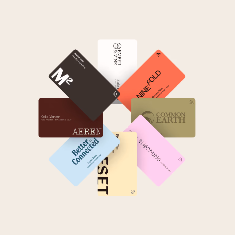 Eight custom Blinq NFC business cards fanned out, each printed with a different company logo, name and job title