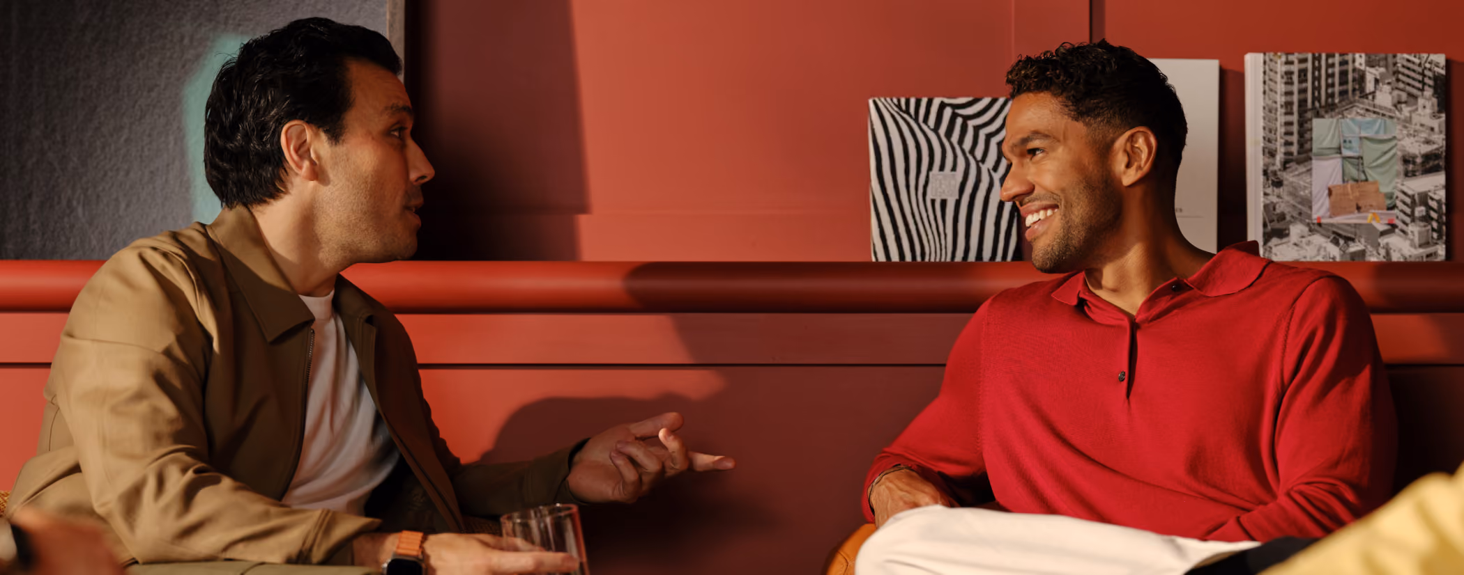 Professionals having an informal conversation over drinks - the kind of relationship-building moment Blinq's AI Notetaker is designed to capture