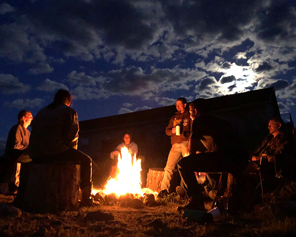 family gathering around a fire