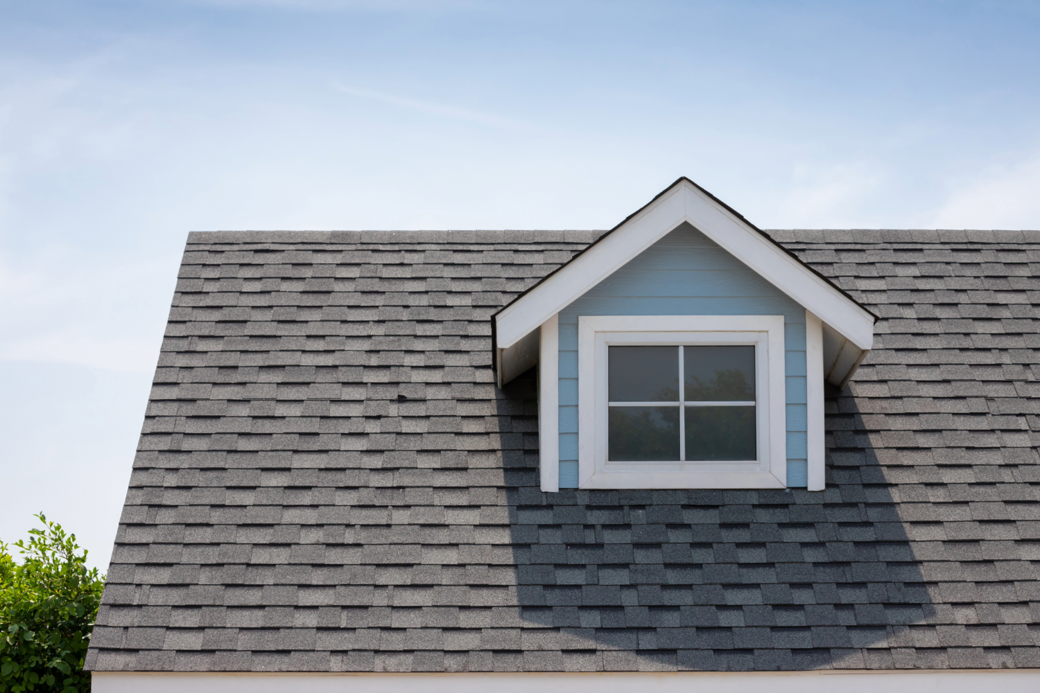 Shingled roof with dormer window.