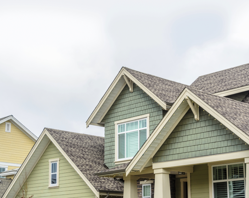 Suburban homes with grey roofs.