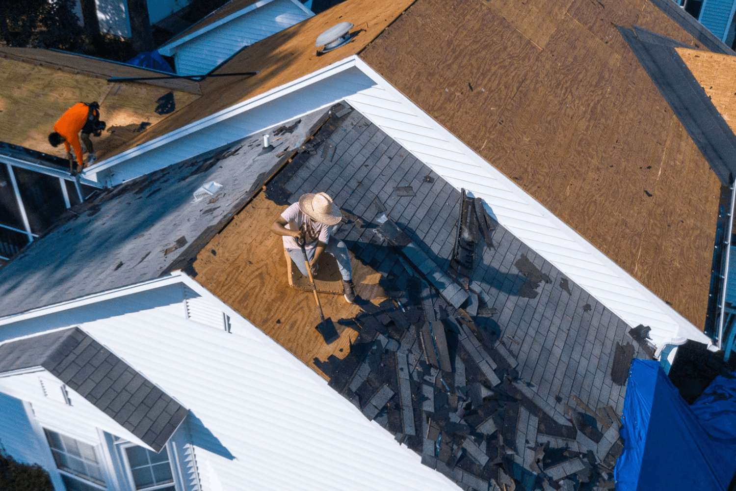 Roofers repairing a house roof in San Antonio.