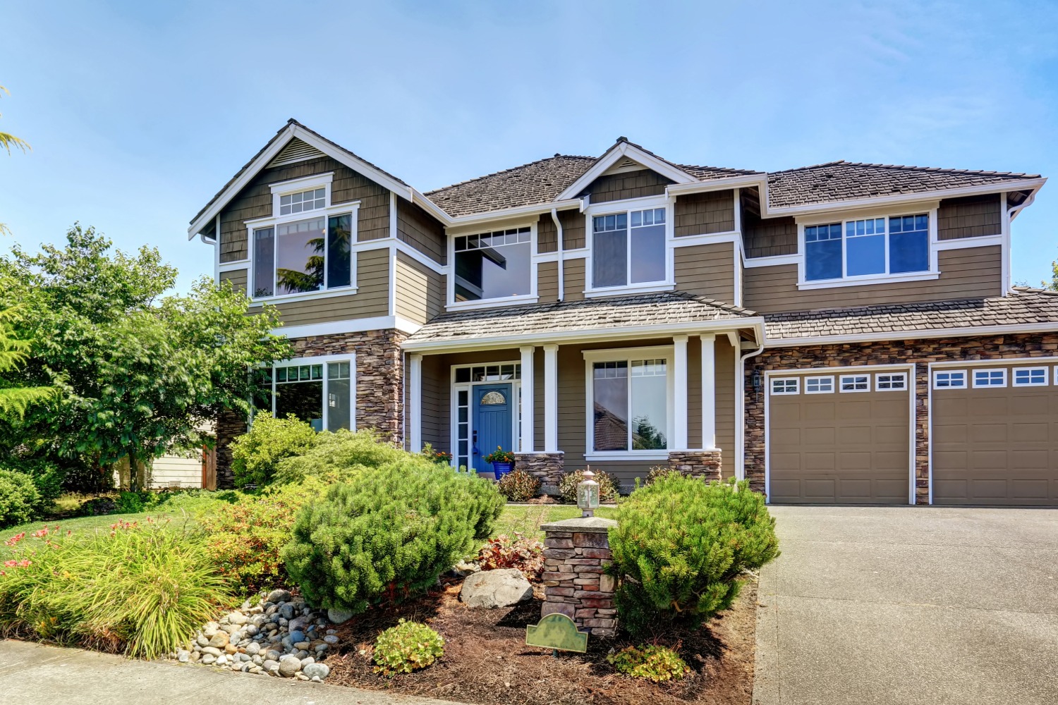 Two-story house with shingle roof.