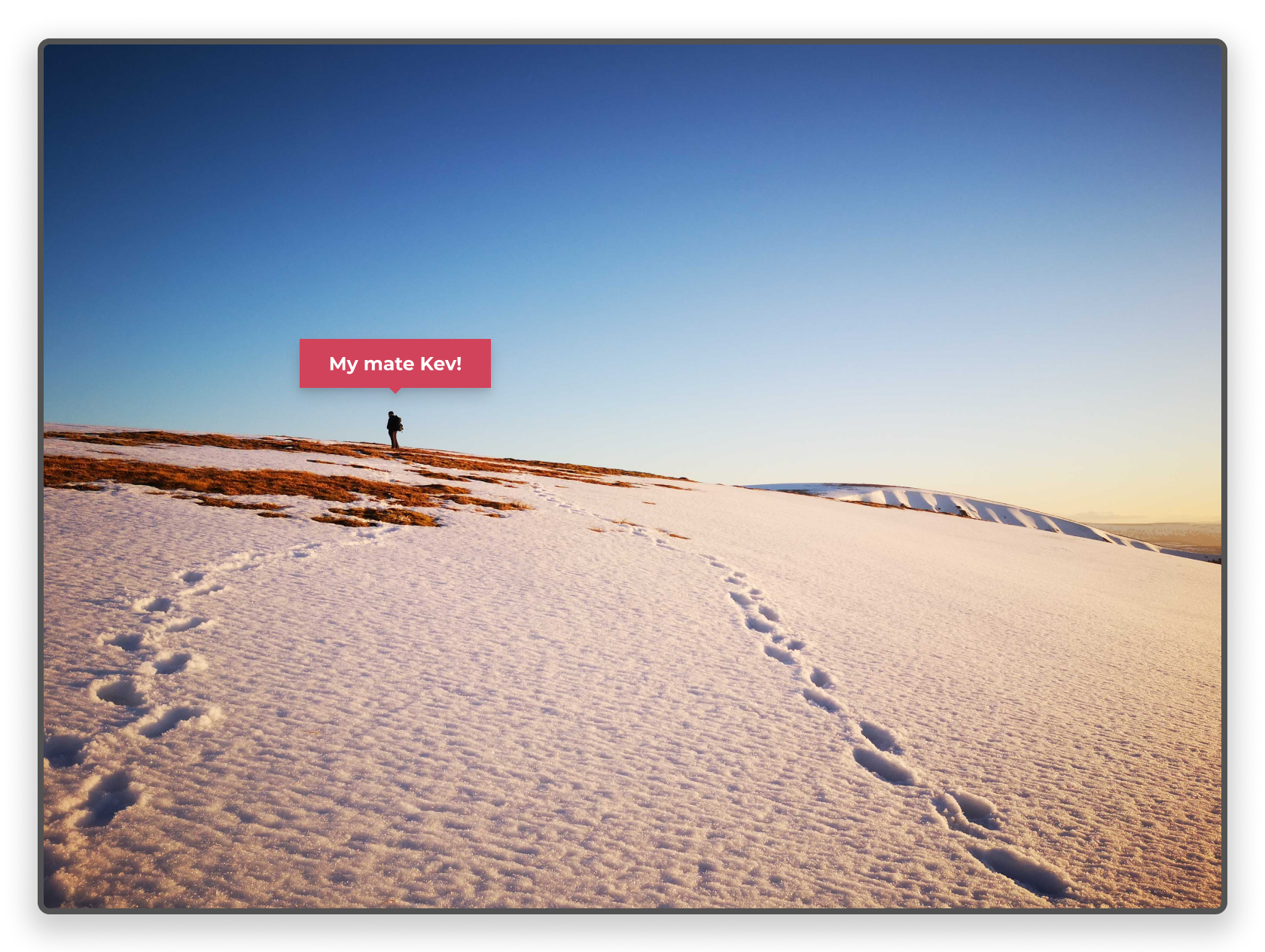 My friend Kev on top of a snow covered hill that we have climbed