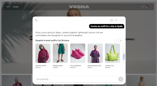 A fashion ecommerce storefront with an AI shopping assistant overlay. The assistant is responding to a request to “Curate an outfit for a trip to Spain” and recommends a collection of lightweight travel items, including a jacket, shorts, sneakers, a tee, and a tote bag. Product images, names, and prices are displayed in a carousel, while a text input field at the bottom invites shoppers to continue the conversation.