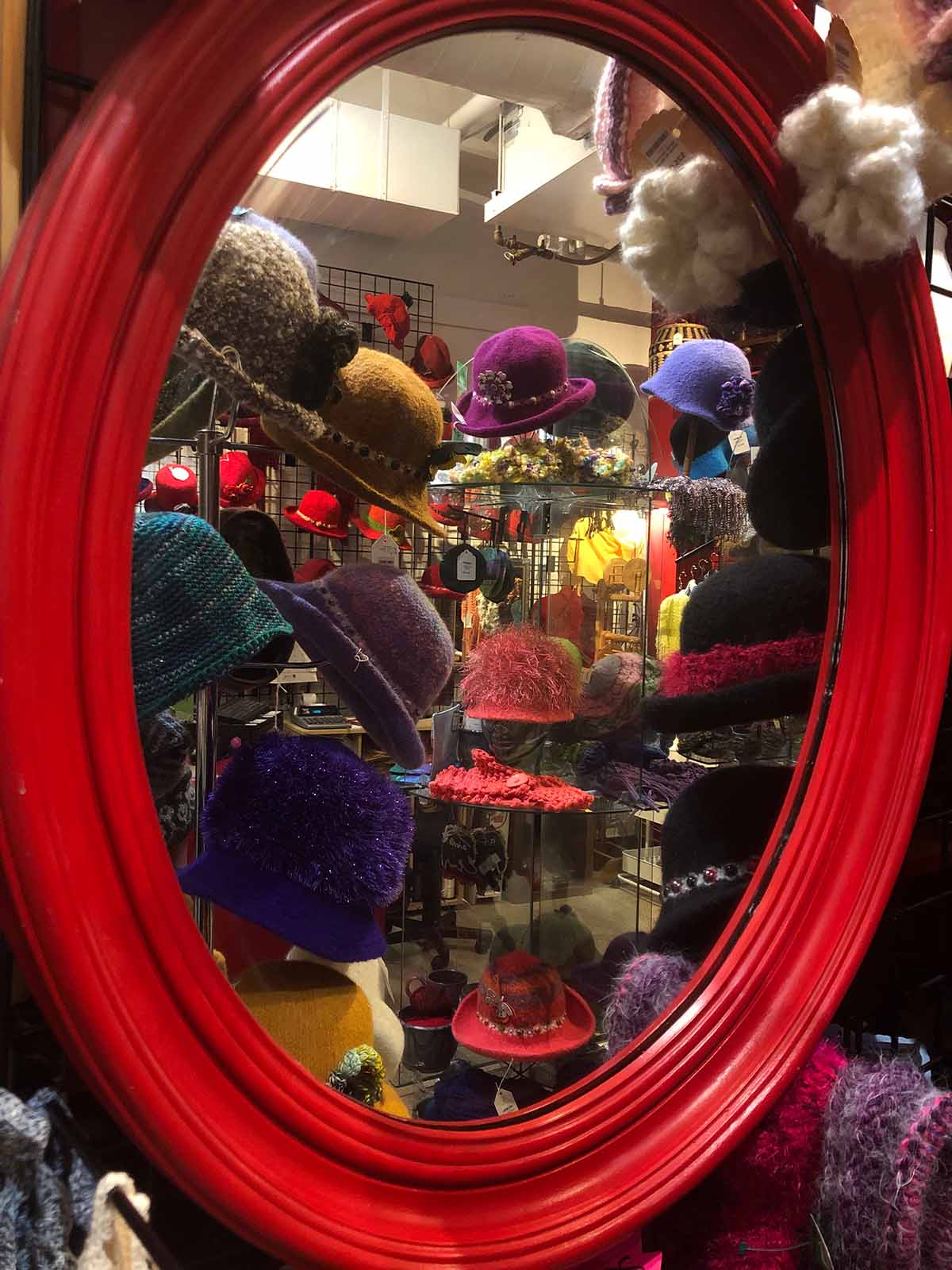 Store interior of hat display at Asheville Home Crafts shop