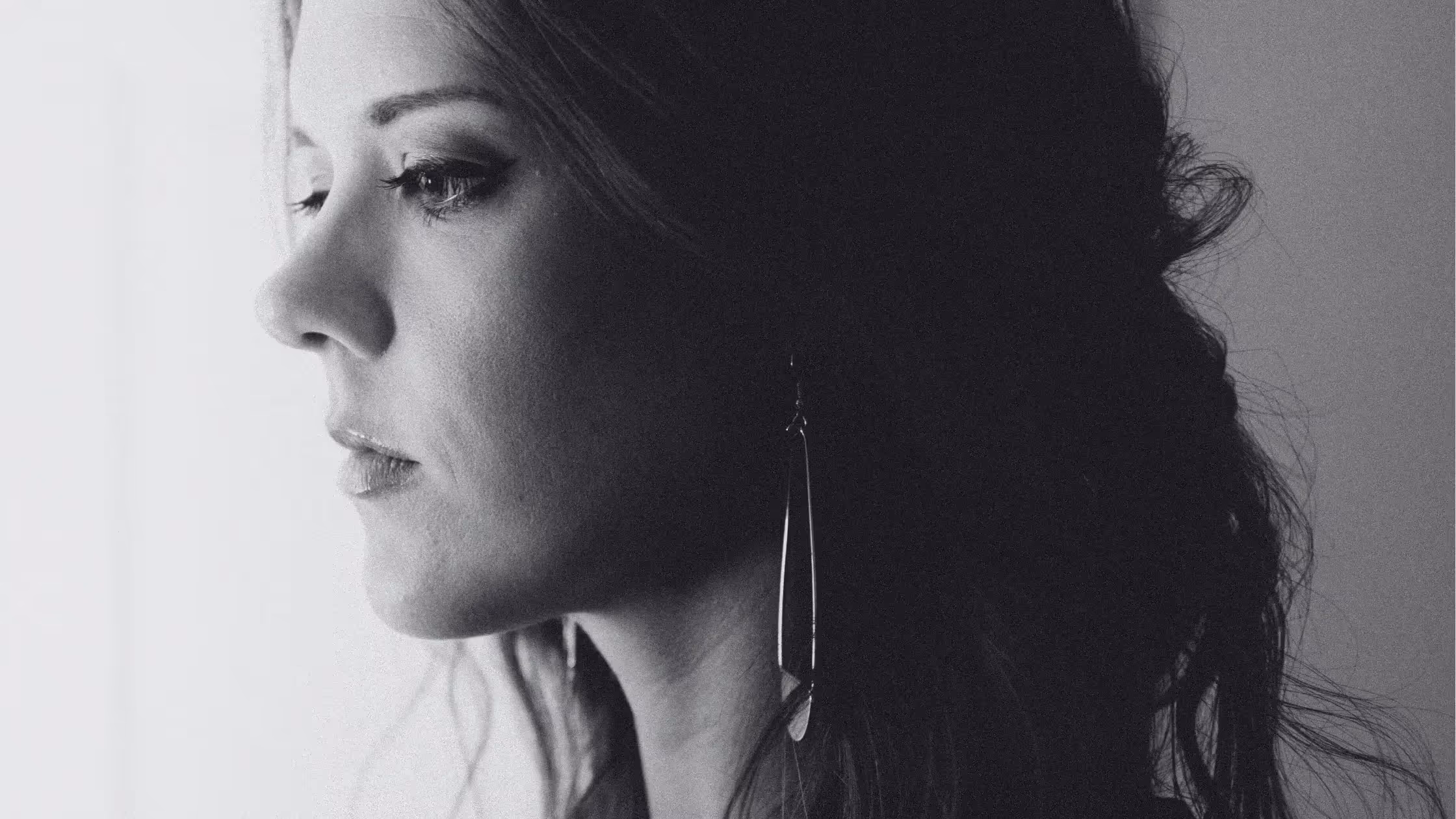 The eyes of a young woman ponder confirmation bias. 
