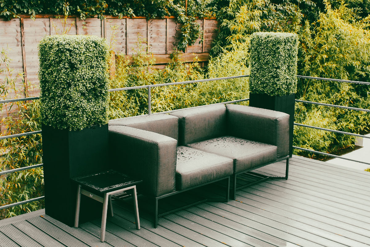 Mixed planting fake green wall used as screening