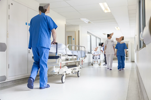 Medical tech pushes a gurney through the halls of the hospital past staff and patients, thinking about the best practices for video redaction.
