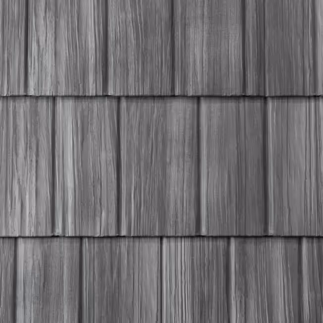 Gray textured metal roofing panels designed to resemble wooden shake shingles.