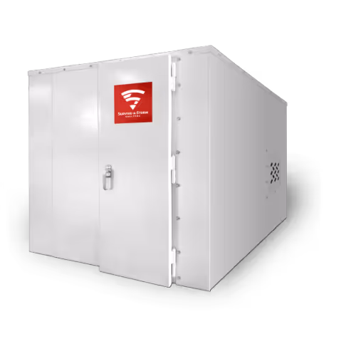 Large white industrial metal enclosure with a door featuring a red Sunwave Storm Shelter logo.