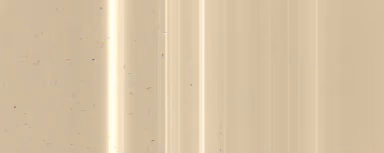 Close-up of a beige marble surface with soft vertical streaks and natural speckles.