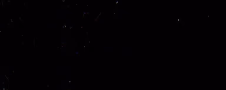 Close-up of black textured metal surface with subtle reflective spots.