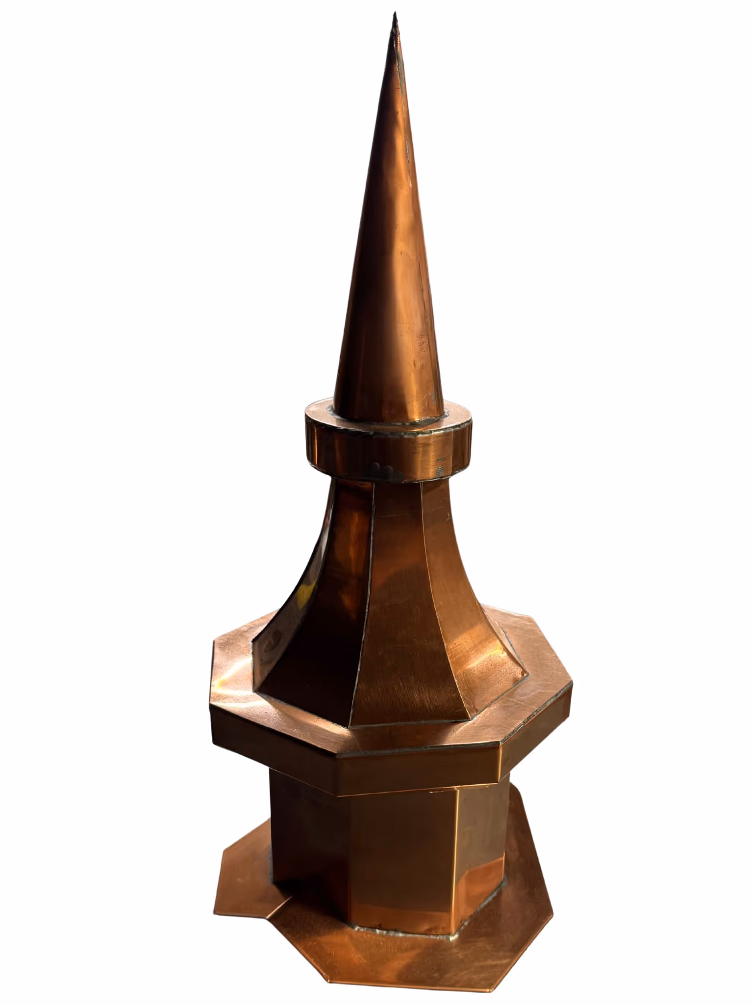 Copper architectural finial with a pointed spire and octagonal base.