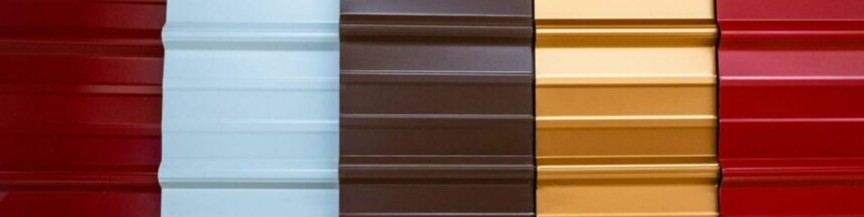 Close-up of horizontally ribbed metal panels in red, light blue, dark brown, mustard yellow, and red colors.