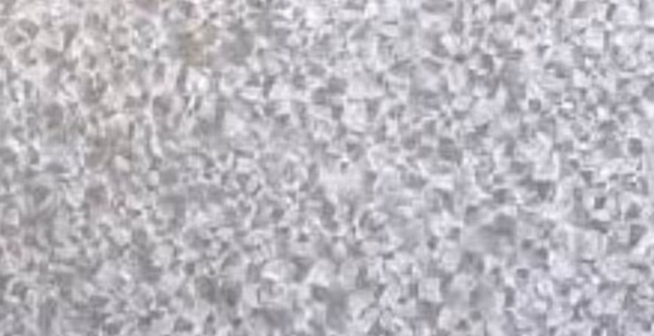 Close-up texture of galvanized steel surface showing metallic crystalline patterns.