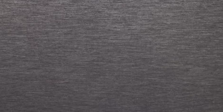 Close-up of gray textured surface with fine horizontal brush strokes and variations in shading.