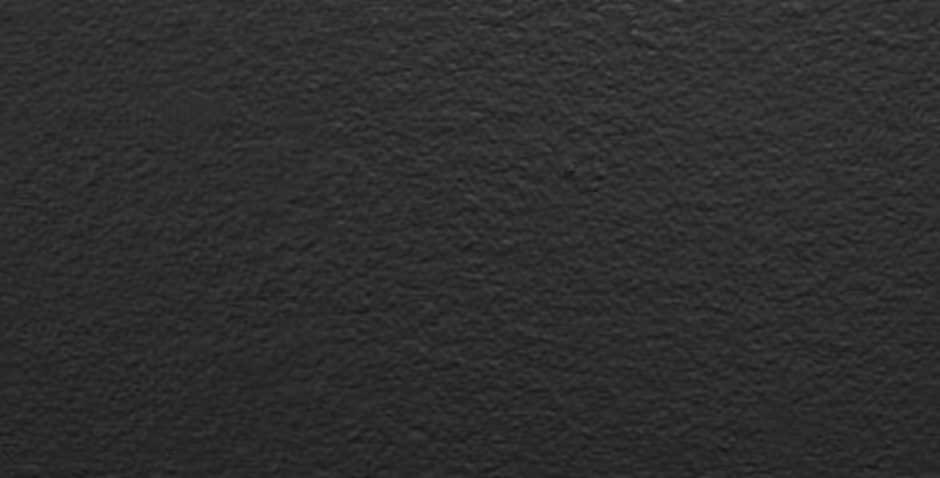 Close-up of a textured black surface, resembling rough leather or a similar material.