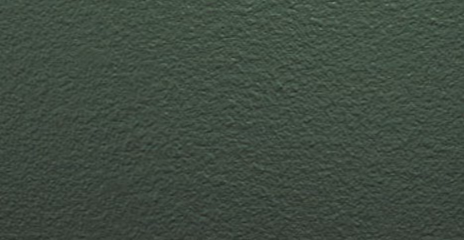 Close-up texture of a dark green painted rough surface.