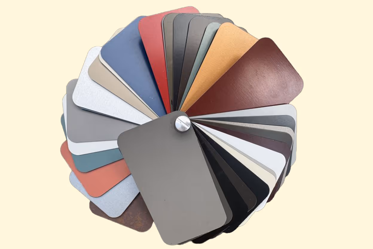 Fan of rectangular metal color swatches in various shades including reds, browns, blues, grays, and blacks.