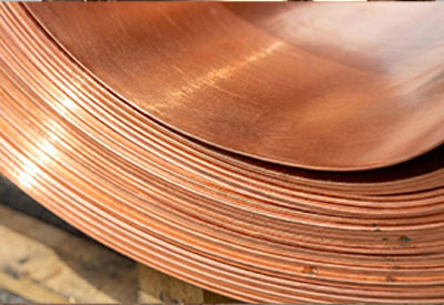 Close-up of a large copper coil with thin, tightly wound copper strips.