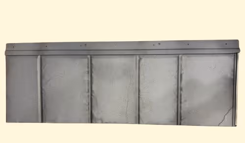 Long gray metal panel with vertical ridges and a slightly bent top edge.