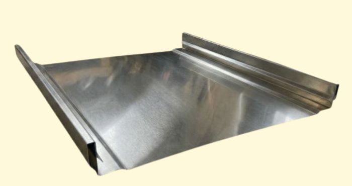 Shiny metal sheet with raised edges on two sides, isolated on a light background.