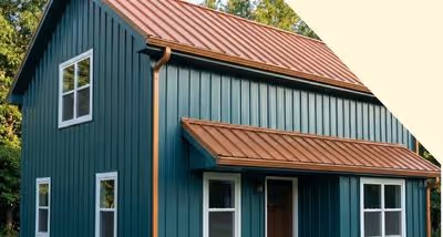 Green vertical board siding house with a reddish-brown metal roof and several white-framed windows.