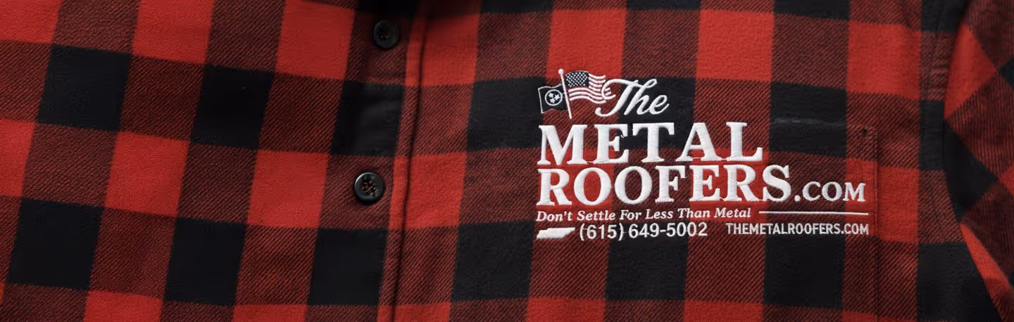 Red and black checkered shirt with a white embroidered logo reading 'The Metal Roofers.com Don't Settle For Less Than Metal (615) 649-5002 THEMETALROOFERS.COM'.