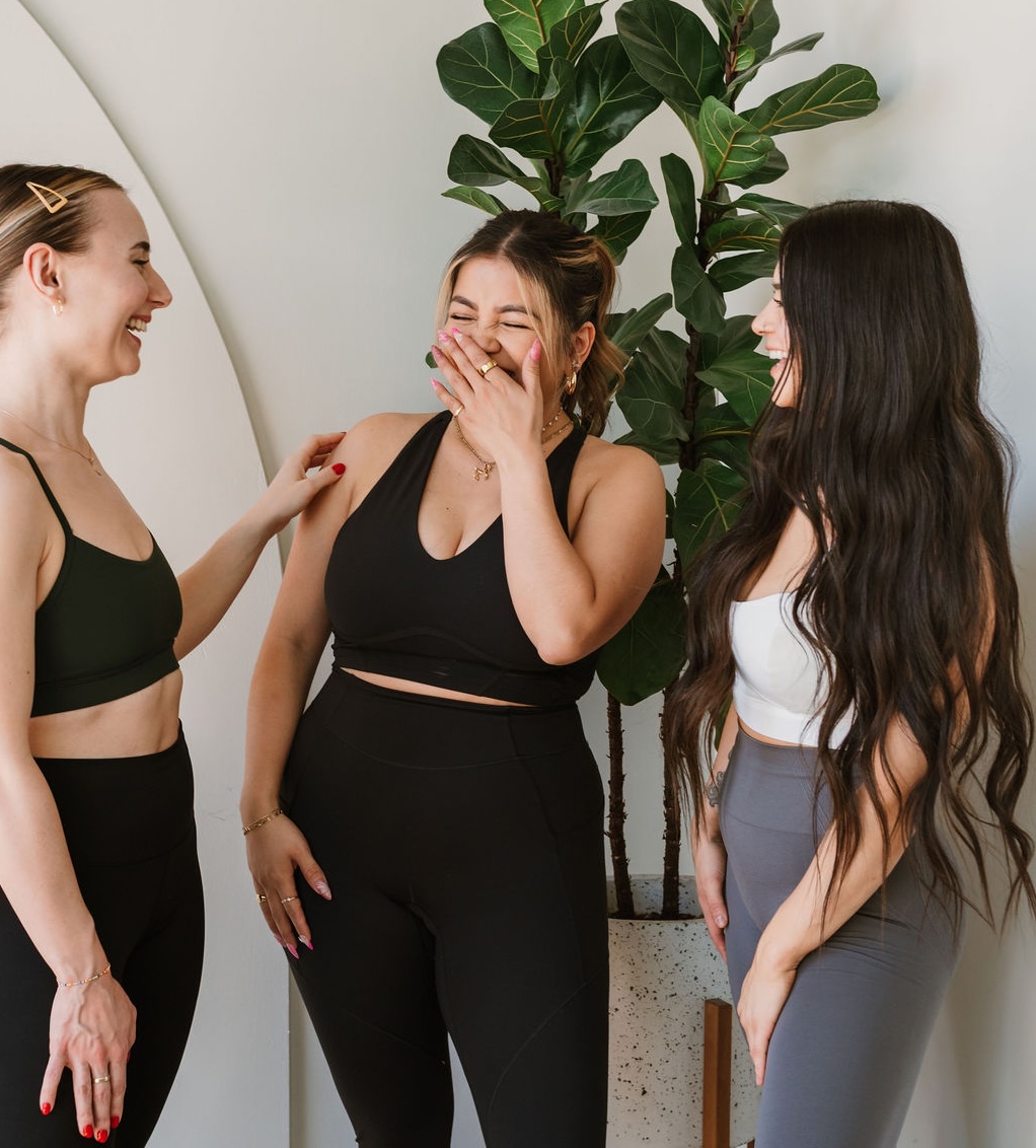 Rider on stationary bike doing bicep curl with weights