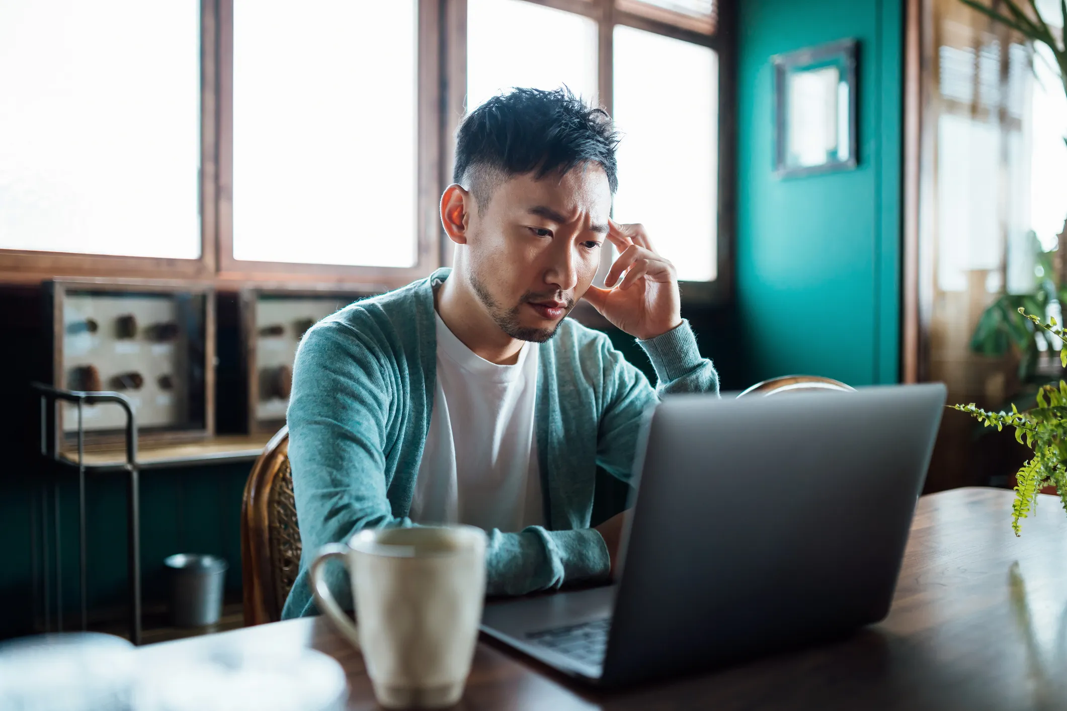 Man fighting burnout while working remotely. Kudos won't only level up your recognition game, but it will also look after your employee's wellbeing.