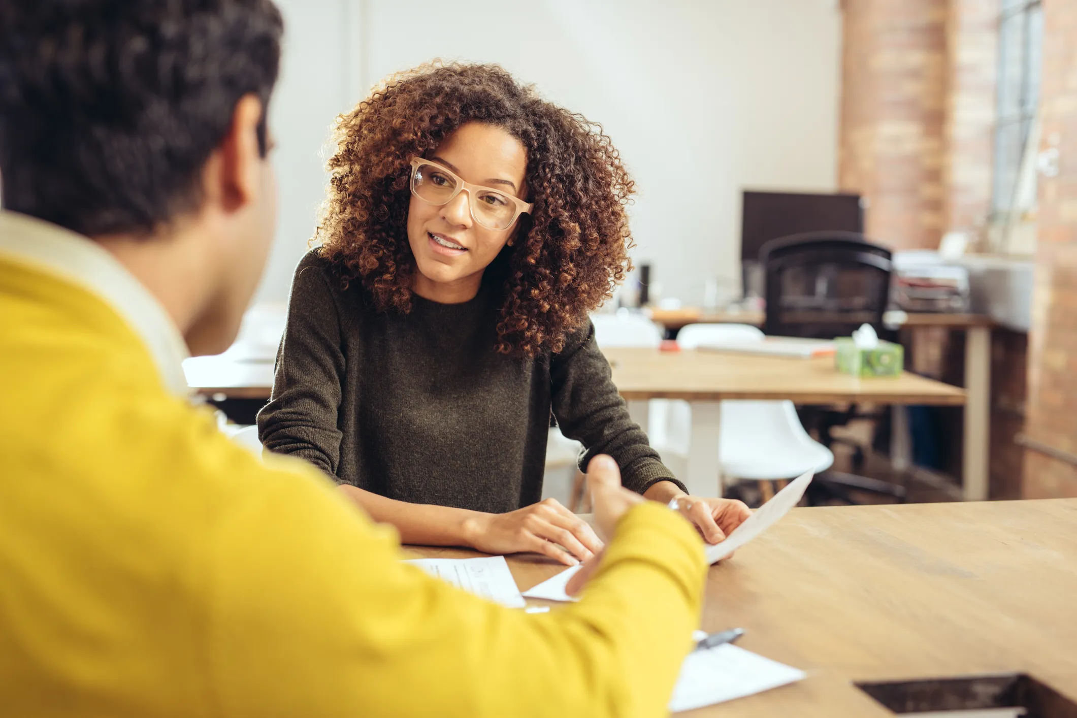 Woman performing a work interview with a potential candidate. She knows the best fit will reinforce the organization’s culture and participate in Kudos.